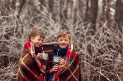 children-drink-hot-chocolate-warm-blanket-winter-forest-christmas-vacation