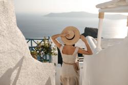 lady-holds-straw-hat-woman-beige-dress-with-bag-goes-down-sea